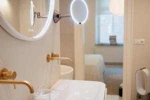 a bathroom with a sink and a mirror on the wall at Onder de Linde B&B in Valkenburg
