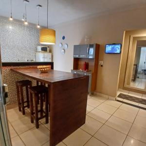 a kitchen with a large island in the middle at Casa Aconchego! in Uberaba
