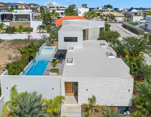 an aerial view of a white house with a swimming pool at Long Lap Pool - Modern Villa - Jan Thiel Beach in Jan Thiel