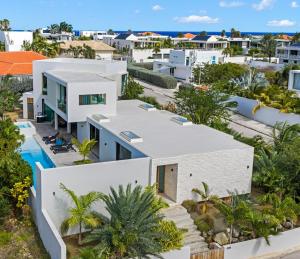 an aerial view of a white house with a swimming pool at Long Lap Pool - Modern Villa - Jan Thiel Beach in Jan Thiel