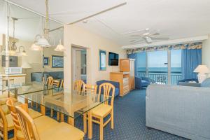 a dining room and living room with a table and chairs at Yachtsman S406 2 BR in Myrtle Beach