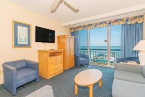 a living room with a couch and chairs and a television at Yachtsman S406 2 BR in Myrtle Beach +59 photos