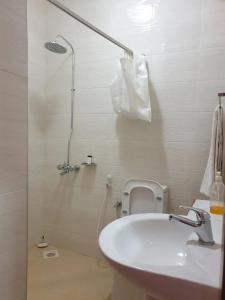 a white bathroom with a shower and a sink at Kilimanjaro pazuri summit villas 1 in Msaranga +65 photos