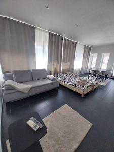 a living room with a couch and a bed at Boom Station & Schorre Suites in Boom +19 photos