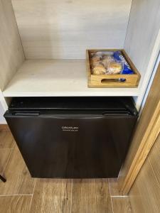a black dishwasher with a box on top of it at Hostal La Mancha in Ruidera