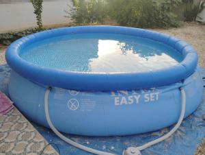 a large blue inflatable swimming pool with a hose at Villa Alhucemas in Imzoûrene
