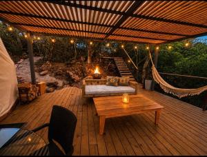a patio with a couch and a table and lights at Arequita Lodge in Minas