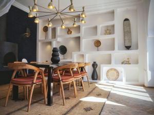 a dining room with a table and chairs at Villa Marrakech Beldi in Najem