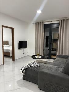 a living room with a couch and a table at Apartments Aroma in Tomba