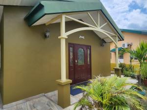 a house with a brown door with a blue roof at Alluring Ambrosia in Arouca