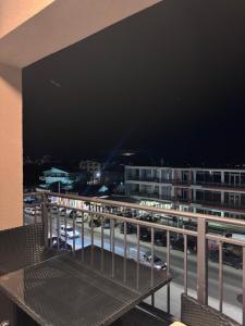 a balcony with a view of a city at night at Apartments Aroma in Tomba