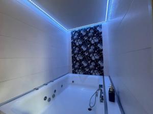 a white bath tub in a room with a blue light at Apartment Simone in Lecce +62 photos