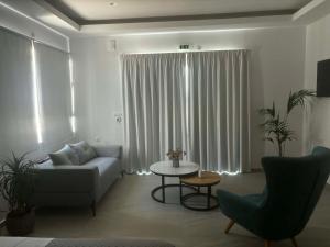 a living room with a couch and a table at Socrates Seaside Apartments in Milatos