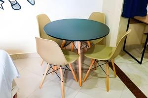a table and four chairs in a room at Casa Marajoara in Soure