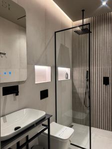 a bathroom with a toilet and a sink and a shower at South Inn Hotel in Vlorë +120 photos