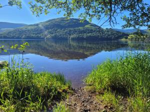 a view of a lake with a hill in the background at Brent Top in Penrith