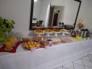a buffet of food on a table in a room at Eduardos Hotel in Rio do Sul