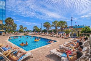 a group of people sitting in chairs in a pool at Oceanfront 1BR by Skywheel Yachtsman 701 in Myrtle Beach
