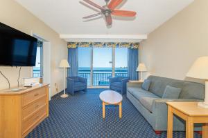 a living room with a couch and a television at Oceanfront 1BR by Skywheel Yachtsman 701 in Myrtle Beach