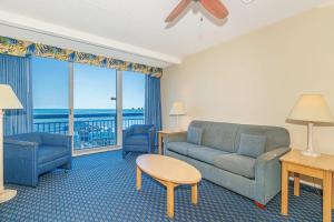 a living room with a couch and a table at Oceanfront 1BR by Skywheel Yachtsman 701 in Myrtle Beach