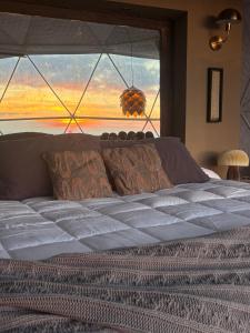 a bedroom with a large bed with a large window at Arequita Lodge in Minas +9 photos