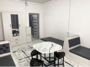 a room with a table and chairs and a mirror at 888 отель in Yunusobod