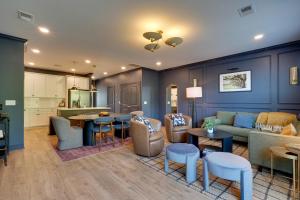 a living room with a couch and tables and a kitchen at Dock Access! 'Hook & Heron Lakefront Getaway' in Greenwood