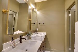 a bathroom with a sink and a mirror at Dock Access! 'Hook & Heron Lakefront Getaway' in Greenwood +21 photos