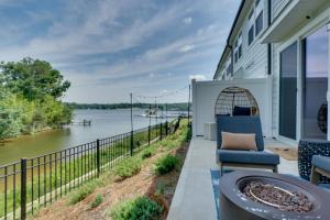 a patio with a view of the water at Dock Access! 'Hook & Heron Lakefront Getaway' in Greenwood