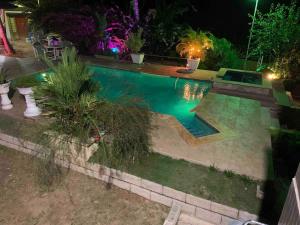 a swimming pool in a yard at night at Casa Vista in Loango