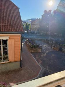 a building with a brick sidewalk next to a street at Not A Hotel Cesis in Cēsis