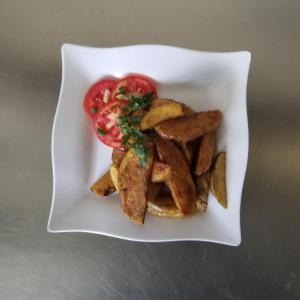 a plate of food with french fries and a tomato at Torchys in Kisumu +30 photos