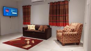 a living room with a couch and a chair at Santa Fe in Port-of-Spain