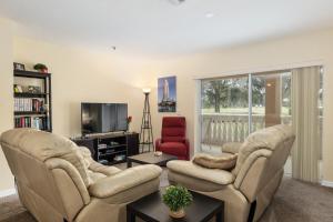 a living room with two chairs and a tv at Condominium at Lakeside Golf & CC - unit 104 apts in Inverness