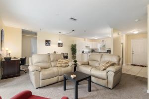 a living room with two couches and a kitchen at Condominium at Lakeside Golf & CC - unit 104 apts in Inverness