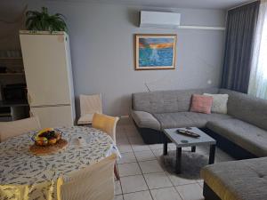 a living room with a couch and a table at Sandra Apartmani 2 in Zaostrog