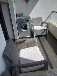 a laundry room with two chairs and a washing machine at Puerto banus beach Apt Famillies and married couples in Mansouria
