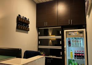 a room with a refrigerator with drinks in it at Hotel Alcaraván Aguazul in Aguazul