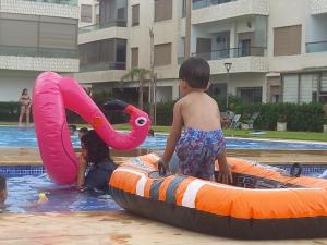 a group of children playing in a swimming pool at Puerto banus beach Apt Famillies and married couples in Mansouria +6 photos