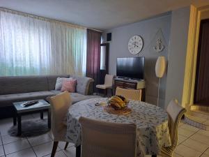 a living room with a table and a couch at Sandra Apartmani 2 in Zaostrog