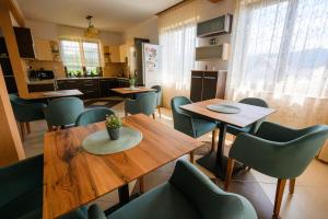 a dining room with tables and green chairs at Casa Leda in Sovata
