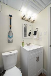a bathroom with a white toilet and a sink at The Beachside Co in Sylvan Beach +21 photos