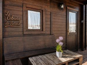 a room with a wooden wall with a table and a door at Villa Soñada Setenil in Setenil