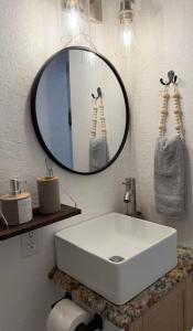 a bathroom with a white sink and a mirror at Small Space Charm in Tampa