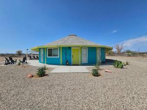 a small house in the middle of the desert at The Round House in Parker