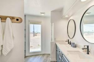 a white bathroom with two sinks and a mirror at The Round House in Parker +56 photos