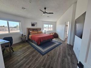 a bedroom with a bed with a red bedspread at The Round House in Parker