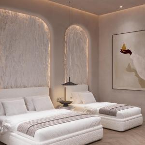 two beds in a room with white walls at Boutique Hotel by Ruci in Terihat +80 photos