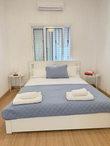 a bedroom with a bed with two towels on it at Harbour No4 in Polis Chrysochous