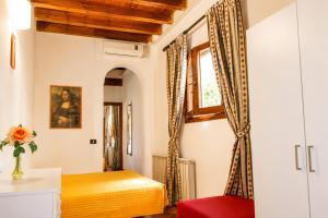 a bedroom with a yellow bed and a window at Max Studios Florence in Florence